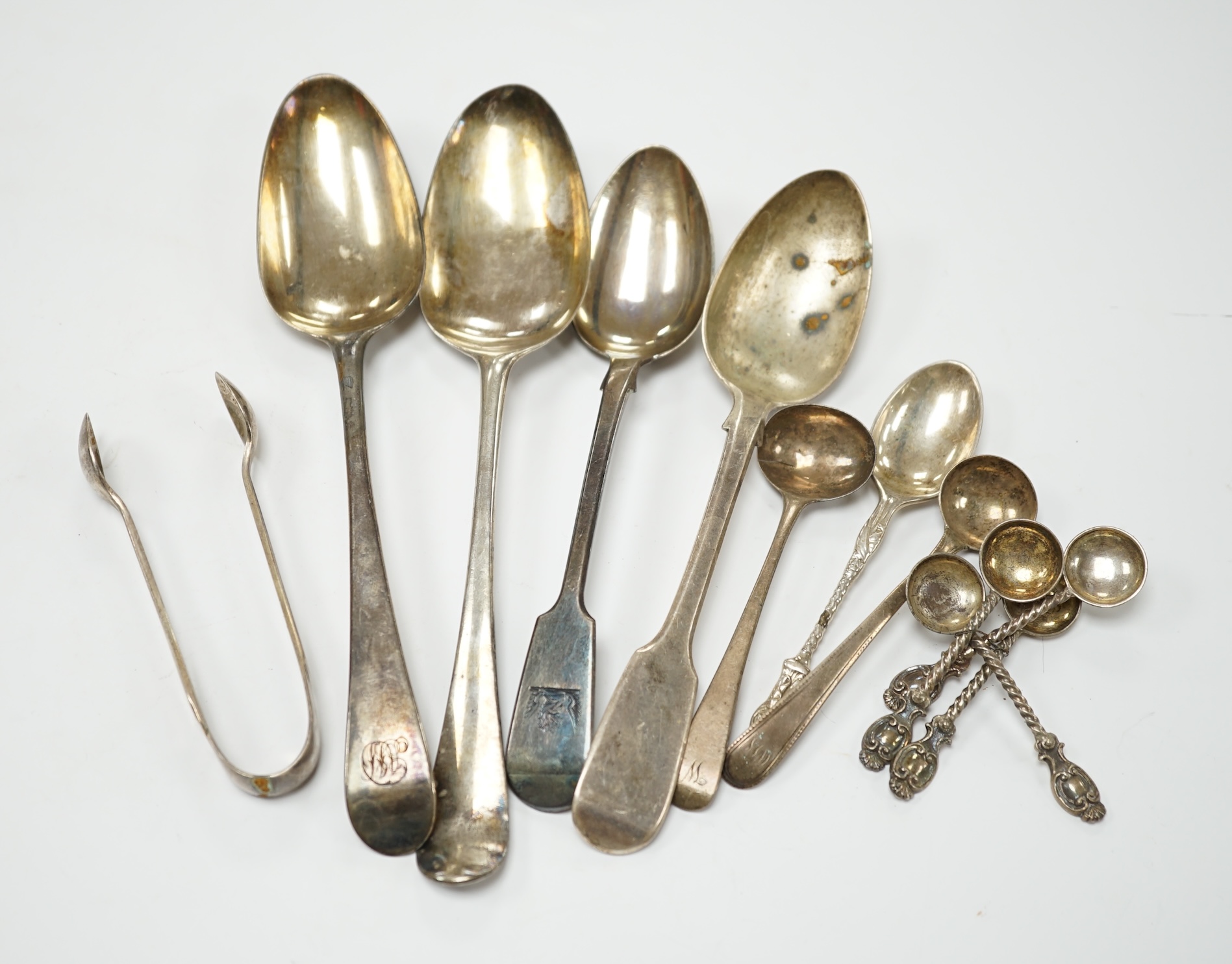 A quantity of mainly 19th century and later silver flatware, including table spoon, dessert spoons, teaspoons, condiment spoons, etc. and other items including two wine labels and a cased 9ct gold mounted amber cigarette